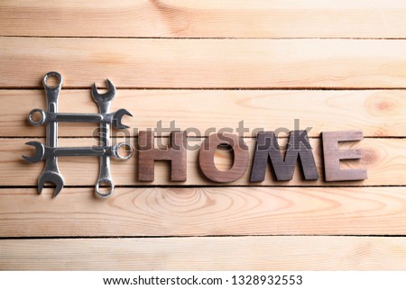 Composition with hashtag HOME on wooden background
