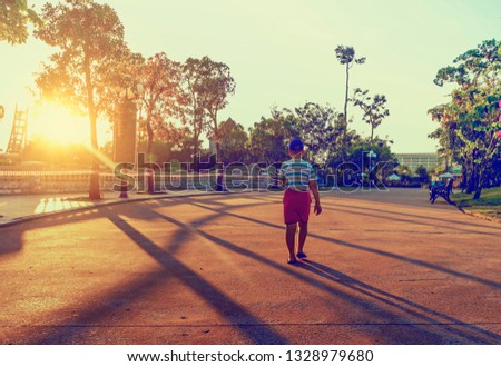 Little boy walking in public park