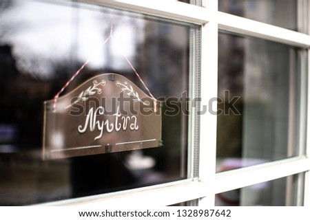"Nyitva" means "Open" in Hungarian language. Open sign at the door. Welcoming and warm sign. Can be used for cafe, restaurant, guest hours. Open symbol. 