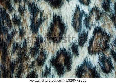 Leopard background, synthetic fur. 
Imitation leopard print texture.