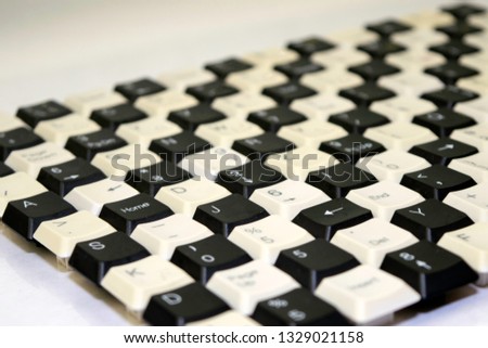 a set of keys from old computer keyboards laid out on the table in a staggered manner