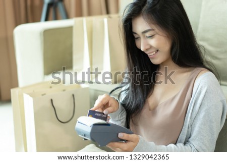Asian girl hand hold card slip on credit card machine in supermarket shopping mall counter service for smart life, internet of things,smart pay, businesswomen online for business service concept