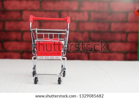 Conceptual photo. Red cart selectively focused.