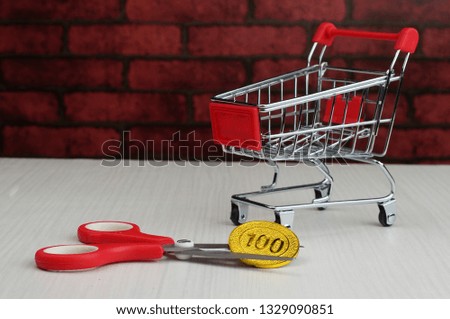 Selectively focused and isolated conceptual photo. Budget cut or constraints for shopping using trolley.