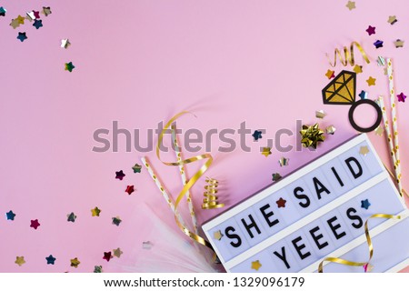 She said yes text with confetti and props on pink background. Wedding party card. Bachelorette invitation. Bridal shower concept. Flat lay Royalty-Free Stock Photo #1329096179