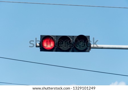 Traffic light  in junction. The red light show indicates all vehicles are parked, not passing by.