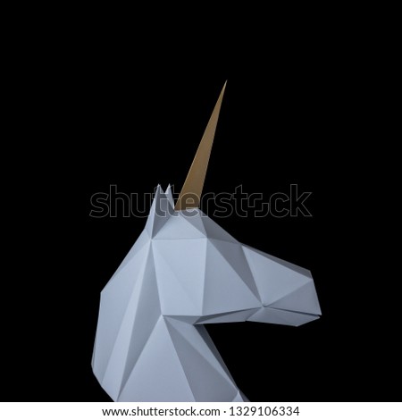 White 3d papercraft model of unicorn head on black background. Minimal art concept.