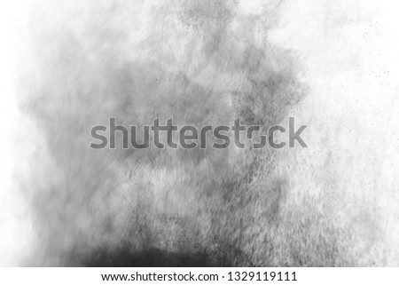 Black particles explosion isolated on white background. Abstract dust overlay texture.
