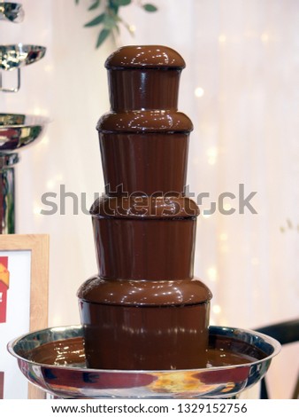 Beautiful delicious chocolate fountain fondue close up.
