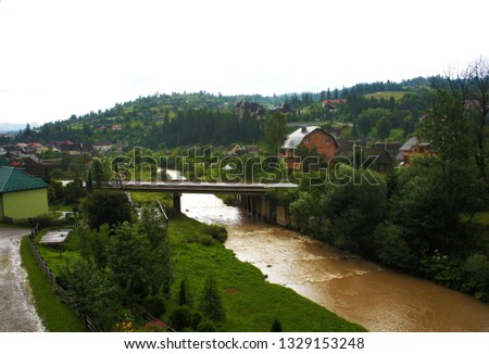 Carpathians bridge. Ukraine dirty river. water flow picture Creek.