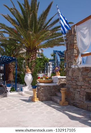 Greek hotel patio with a garden - palm trees, flowers ...