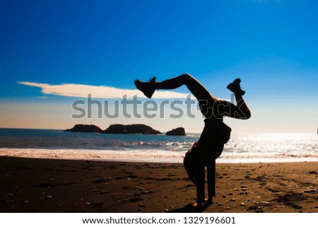 Silhouette of the woman on the beach in Iceland