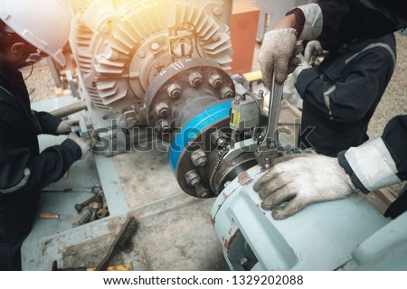 Technician inspector alignment pump  and electric motor, Repairing work in factory concept Royalty-Free Stock Photo #1329202088