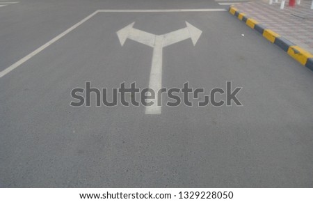 Tarmac (asphalt) road with road signs and symbols  painted by White color painted and posted as shutter stock images