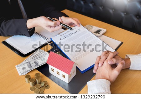 Real Estate developer Agent and sign on document giving keys of new house, Property agent giving offer to buyer 