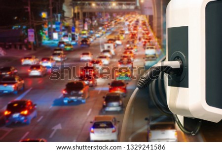 Electric vehicle , Smart car , Air pollution and reduce greenhouse gas emissions concept. Double exposure of charging Electric car with power cable supply plugged in and city night light view. 