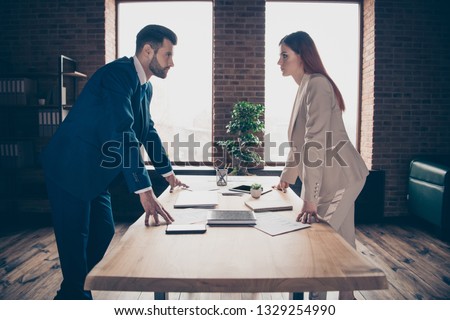 Close up photo two partners she her business lady he him his guy I will get promotion competitive mood strict look eyes who is winner concept stand office table wearing formal wear suit Royalty-Free Stock Photo #1329254990