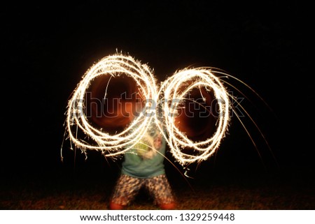 Drawing circles with fire - Sparklers at night with slow shutter speed