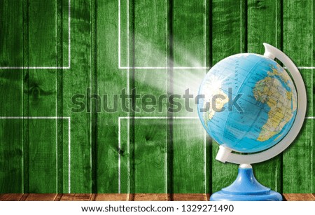 Globe with a world map on a wooden background with the image of the flag of Ladonia. The concept of travel and leisure abroad.