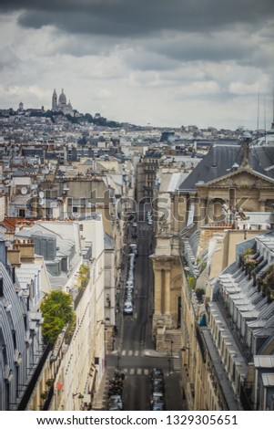 View of Paris, Rue Saint-Roch with Sacre Coeur basilica in the background