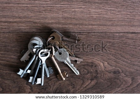 Old keys on old wooden background
