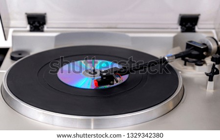 Playing a CD on a record turntable.