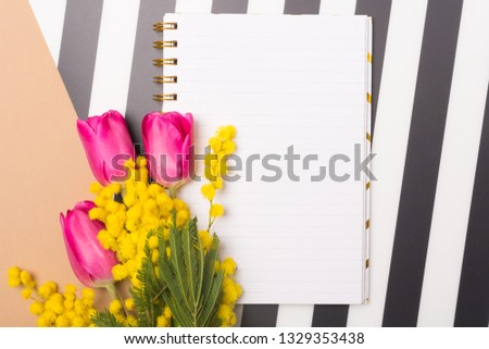Spring flatlay. Spring concept. Fresh and bright background with spring flowers and blank paper. Free space. Copy space.Top view. Tulips and mimosa. Mother's Day. Woman's Day. Love concept.