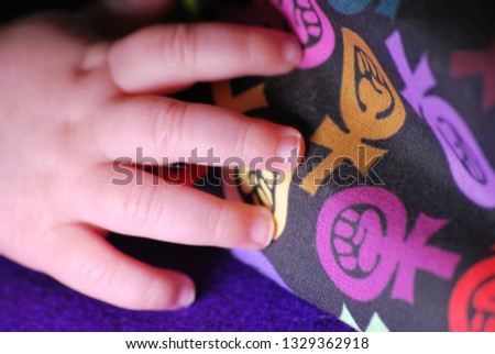 Baby hand with a woman symbols
