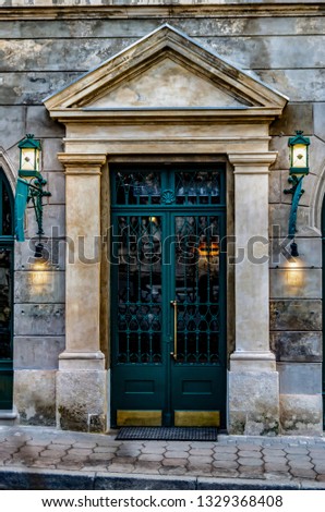 Beautiful double carved wooden front doors. Vintage green doors of european house, main entrance