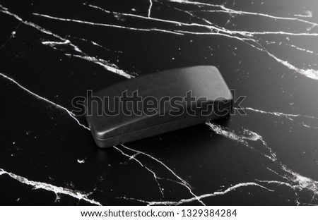 Photo of black leather case on black marble. Template for branding identity isolated on marble background. For graphic designers presentations and portfolios marble premium luxury mock-up. 