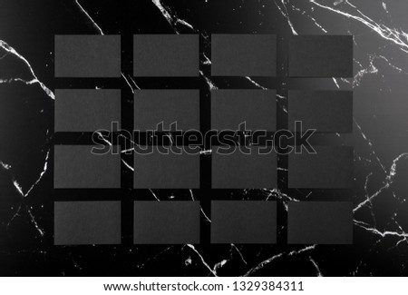 Photo of black business cards on black marble. Template for branding identity isolated on marble background. For graphic designers presentations and portfolios marble premium luxury mock-up. 