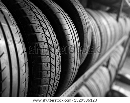 garage equipment car jack tyres black and white picture black tyres rubber bokeh background