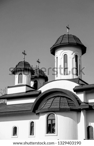 Black and white photography of a Orthodox Christian church roof with three or 3 Jesus cross on top. Clear sky and no clouds. Place for prayer for this religion believers