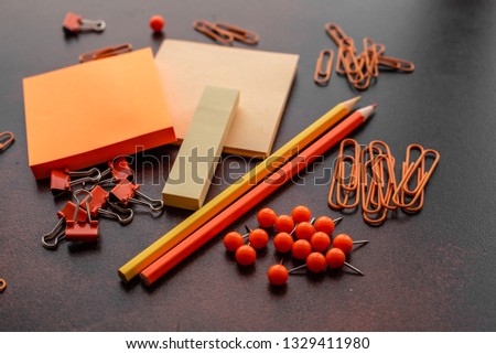 The book, pencil, paper clips and sheets for marks lie on a desktop. It can be used as a background