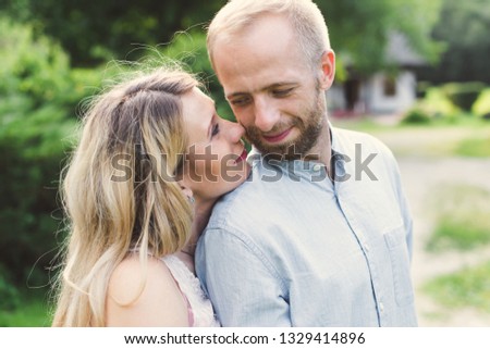 Man and women hug, kiss at sunset. Close-up of a man and woman at sunset.