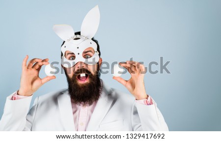 Happy Easter! Easter day. Bearded man in bunny mask holds eggs. Spring holiday. Egg hunt. Easter bunny costume. Easter concept. Man in bunny mask. Rabbit mask.