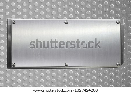 Empty stainless steel plate banner and knot screw on steel plate with a porous circle, copy space for put text character or commercial and message promotion.