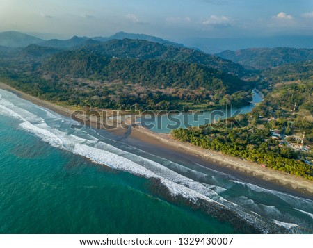 Beautiful aerial view of the Beach in Dominical  and the Baru River in Costa Rica Royalty-Free Stock Photo #1329430007