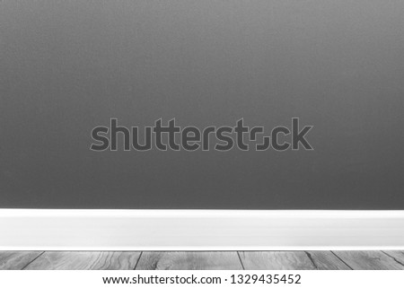 empty grey wall with white plinth and laminate