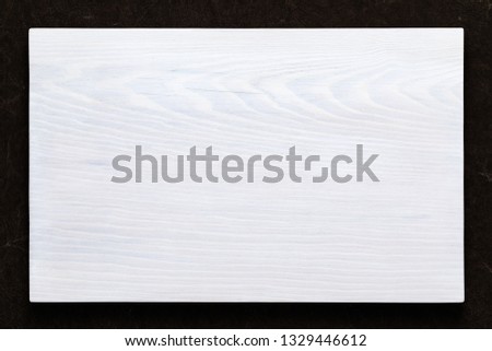 White wooden board on hand smeared burlap
