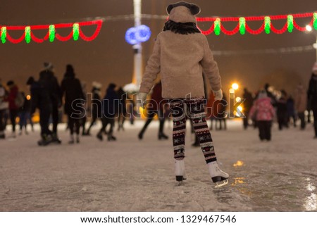 Girl skating on the open rink at Christmas
