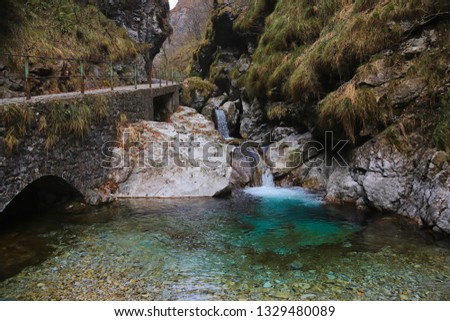 Waterfall and blue river in a quiet valley