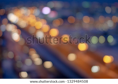 Real photo of the big night city photographed with defokus and blur with an open diaphragm. Bokeh. Motion on the road.