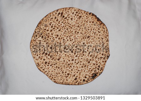 Matza in hand baking in close-up photography