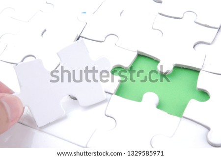 Female hand and missing puzzle on white