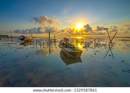 Parking boat with Amazing light of sunrise. This photo take in the one of beautiful morning and beach in Batam island Indonesia.