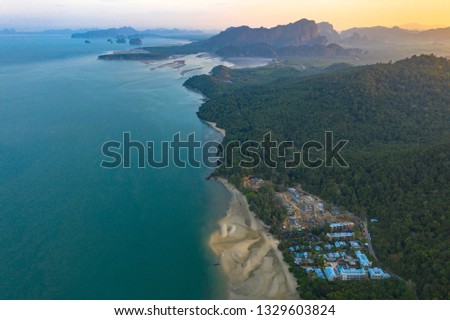Tup Kaek beach close to Kwang beach and Ngon Nak mountain during low tide 
can see long and large beach can walk around many big rocks on the beach 
beautiful sunset behind archipelago in Andaman sea