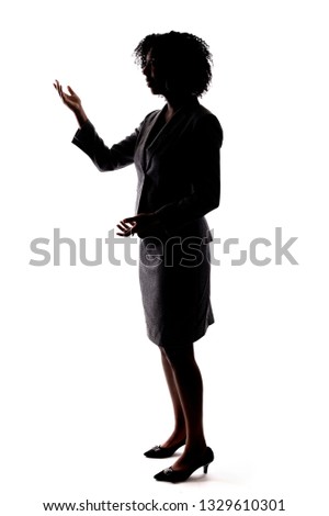 Silhouette of a Black Businesswoman gesturing like she is speaking or giving a speech like a teacher, presenter or a political candidate campaigning. 
