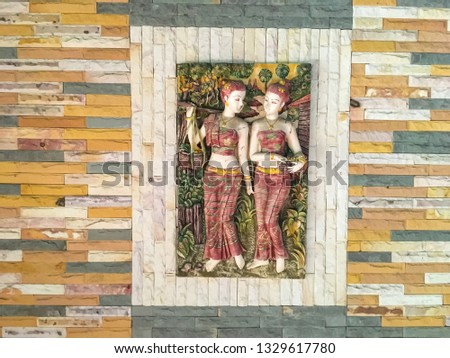 The Art of thai style sandstone carving art on the wall temple or thai home modern style to decorate at the temple in udon thani, thailand