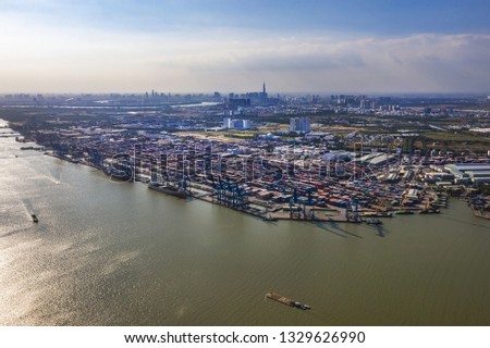 Top view aerial of Cat Lai container harbor, center Ho Chi Minh City, Vietnam with development buildings, transportation, energy power infrastructure.